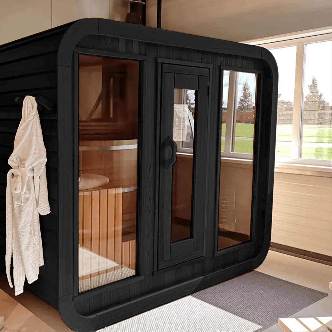 Modern black infrared sauna with glass doors and windows indoors.