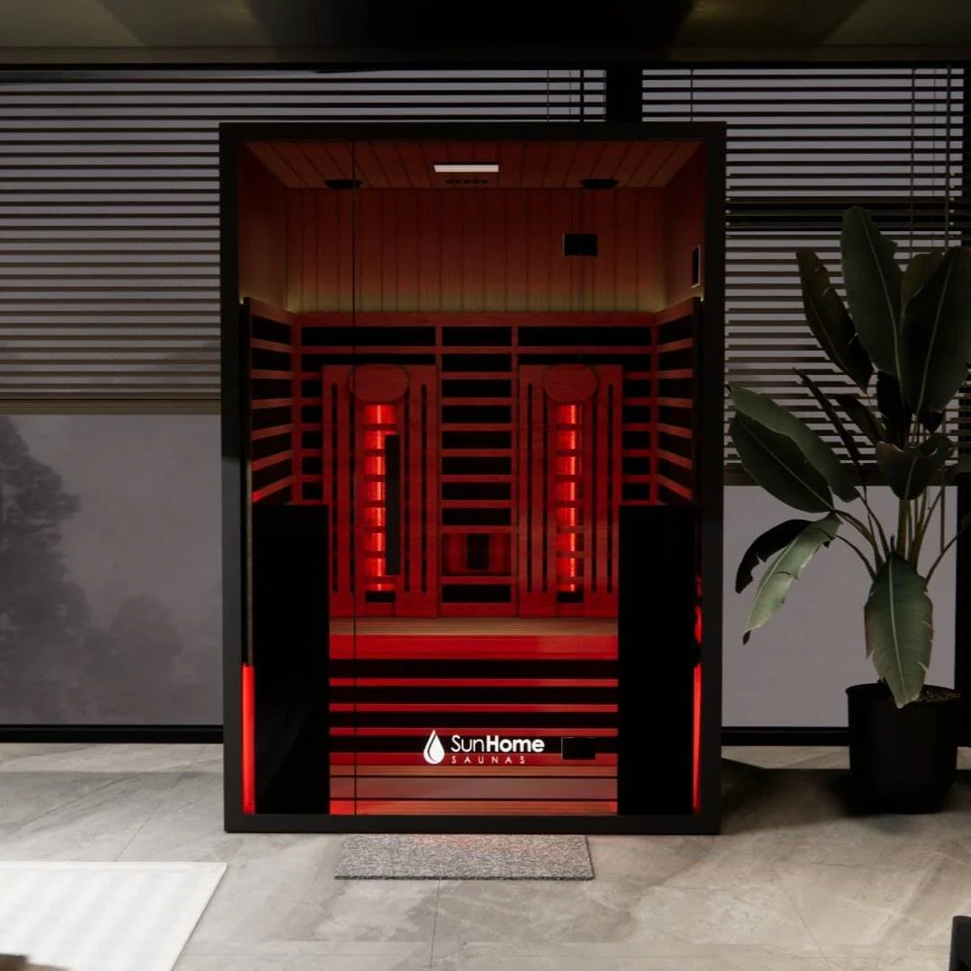 Modern red-lit infrared sauna cabin in a stylish indoor setting.