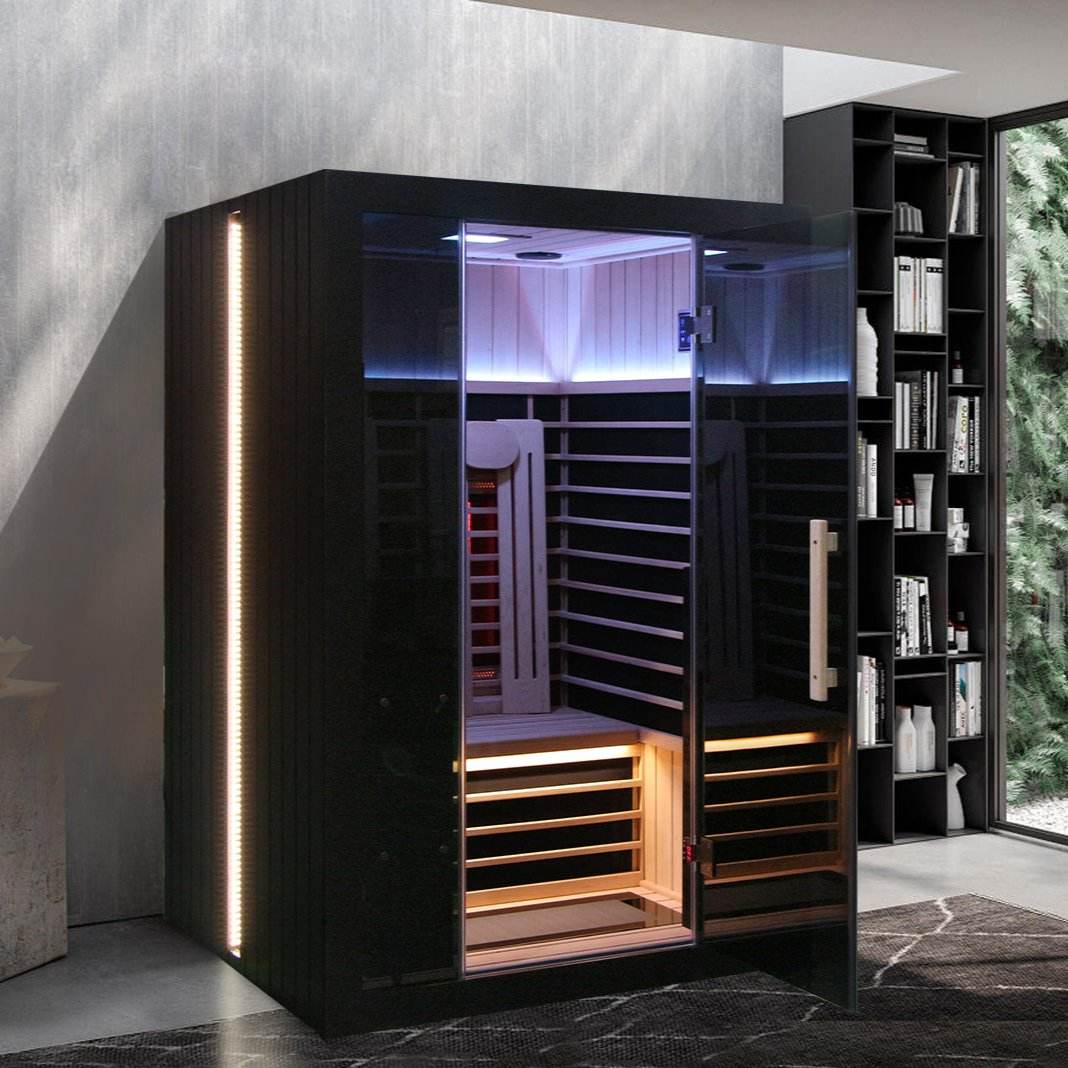 Modern infrared sauna with sleek black design and ambient lighting.