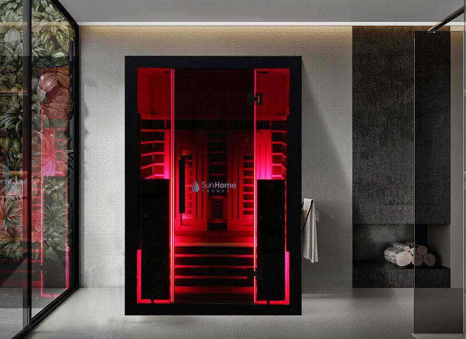Modern red-lit sauna with sleek black glass door in a stylish bathroom.