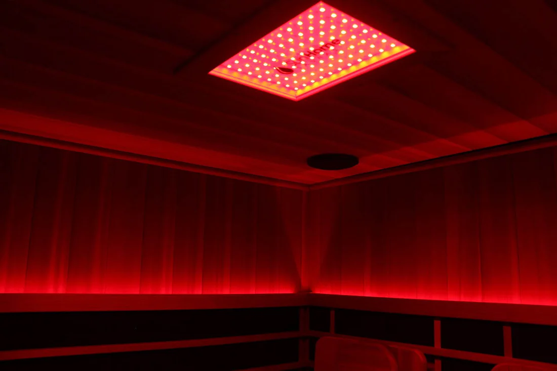 Red-lit room with a glowing ceiling panel.