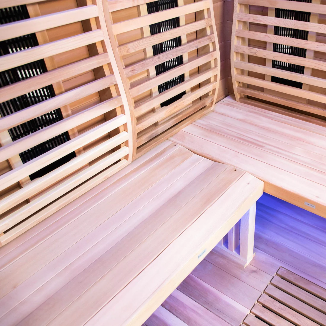 Cozy wooden sauna interior with bench seating and warm lighting.
