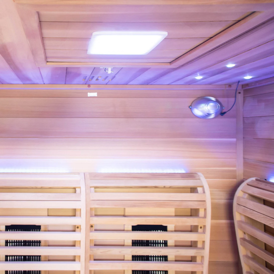 Interior of a wooden sauna with benches and a heater.
