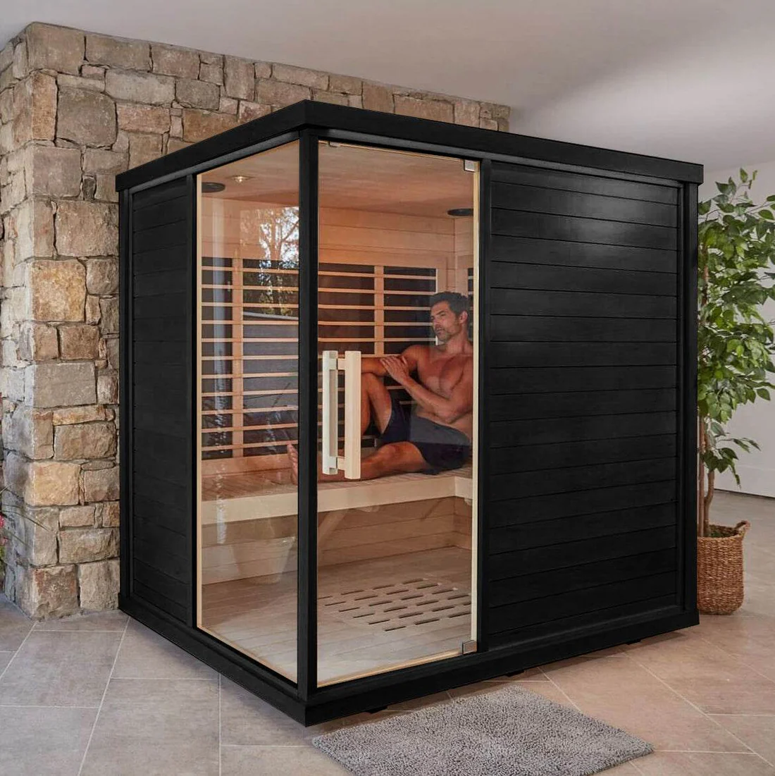 Modern indoor sauna with glass door and wooden interior.