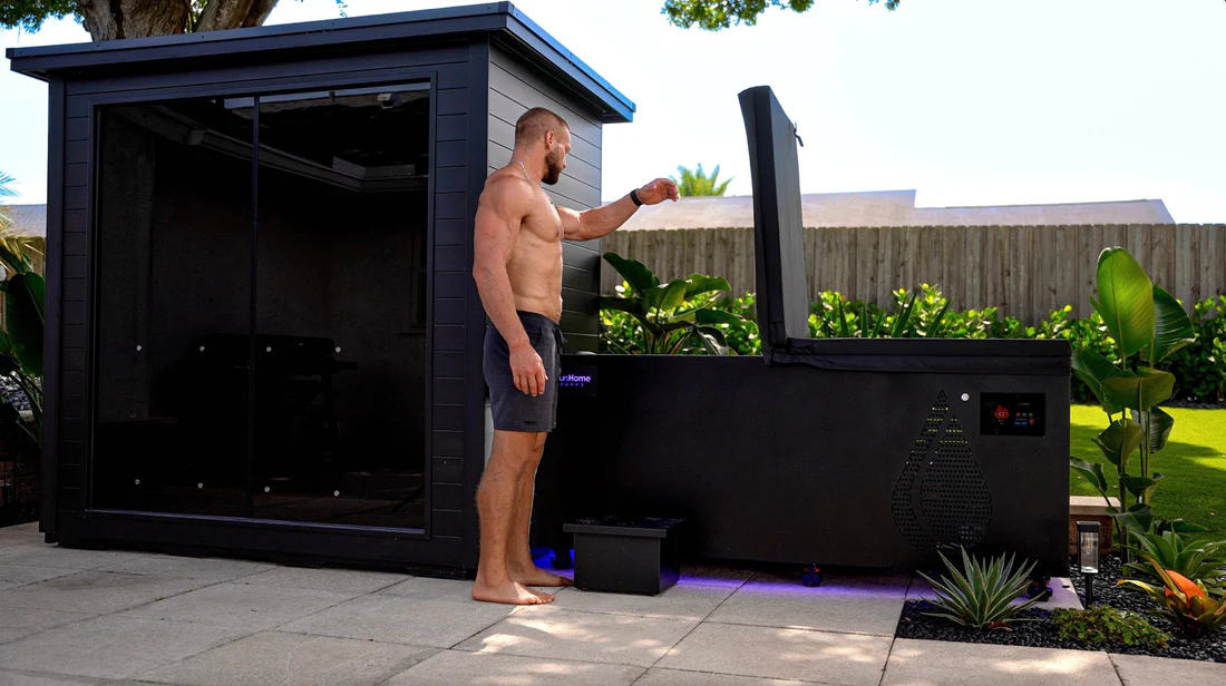 Man using an outdoor hot tub on a sunny day.