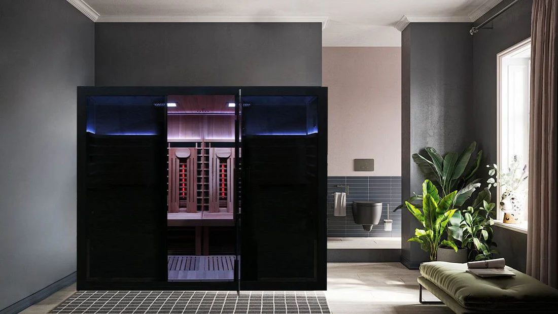 Modern sauna room with sleek black glass doors and ambient lighting.