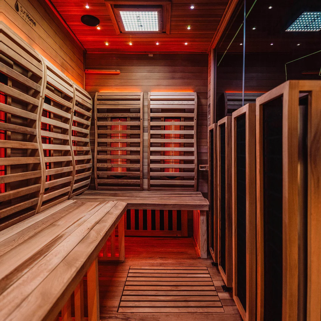 A cozy wooden sauna room with warm lighting and bench seating.