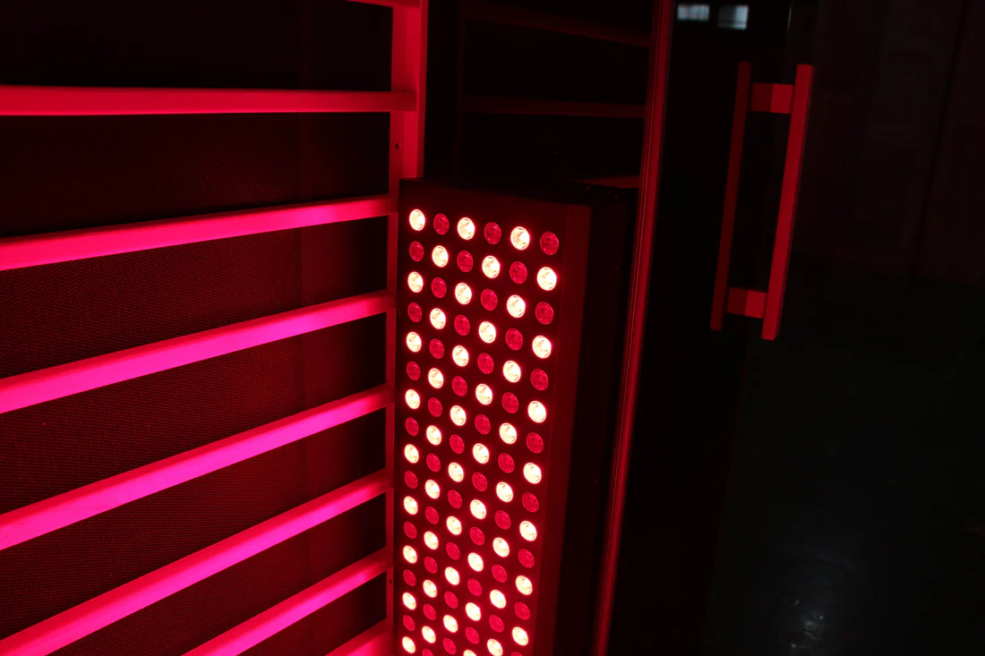 Red LED light panel glowing in a dark room.