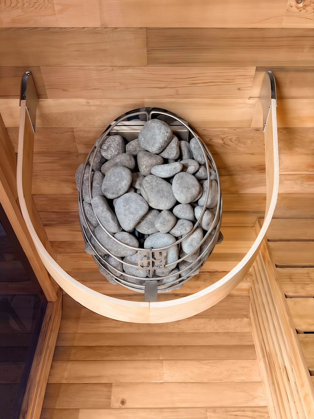 A basket filled with sauna stones on a wooden shelf.