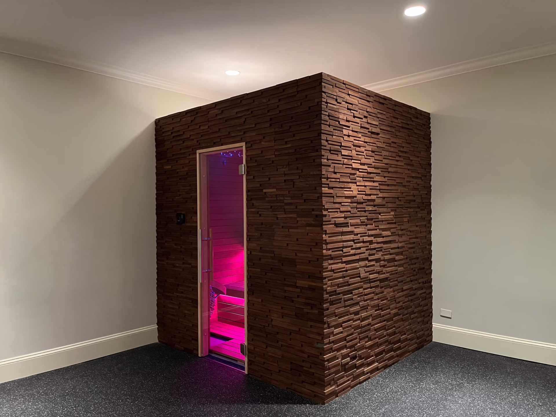 Modern stone room with purple lighting inside.