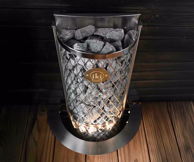 Elegant crystal vase with a glowing light and stones inside.