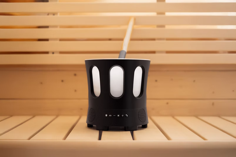 Modern black and white cup with a straw on a wooden surface.