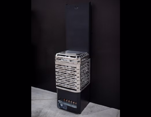 A vintage air cooler with a brick-patterned cover standing against a black wall.