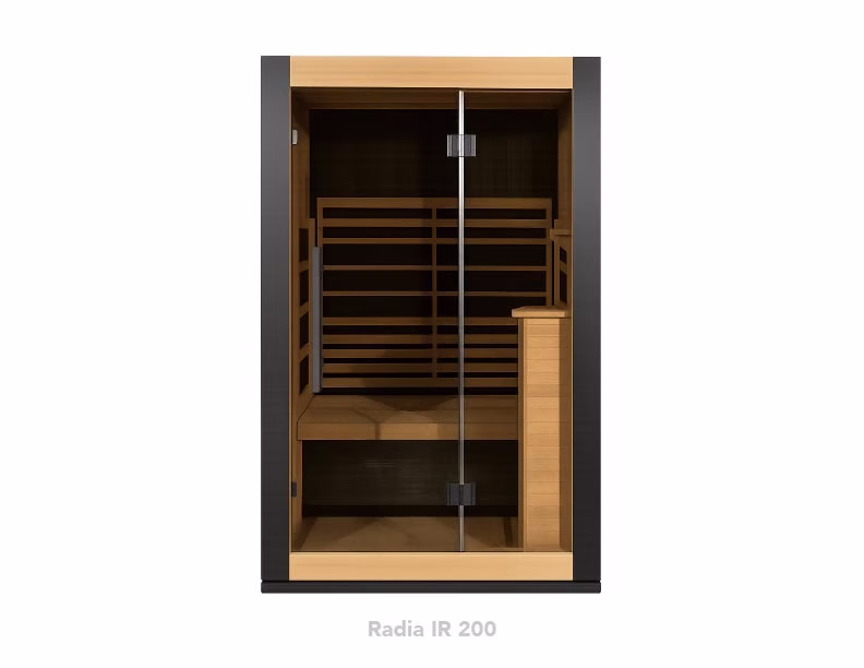 Modern infrared sauna with wooden interior and glass door.
