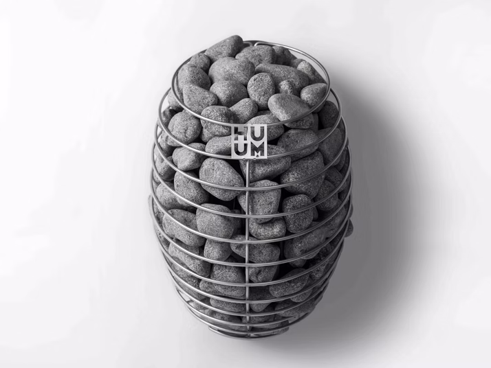 A wire basket filled with potatoes on a white surface.
