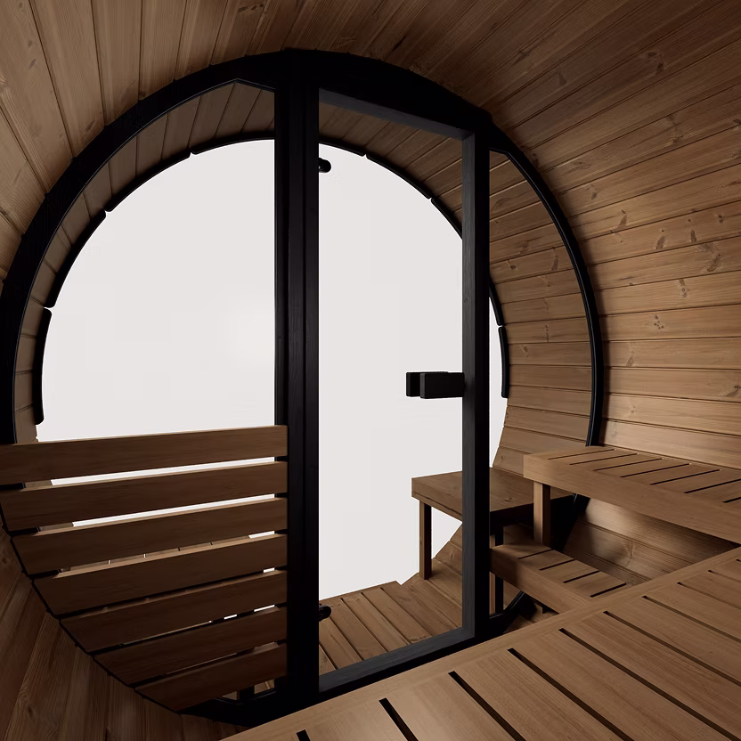 Cozy sauna room with wooden benches and a curved glass door.