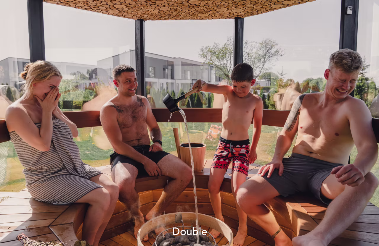 Three men and a boy relaxing with drinks on a sunny day.