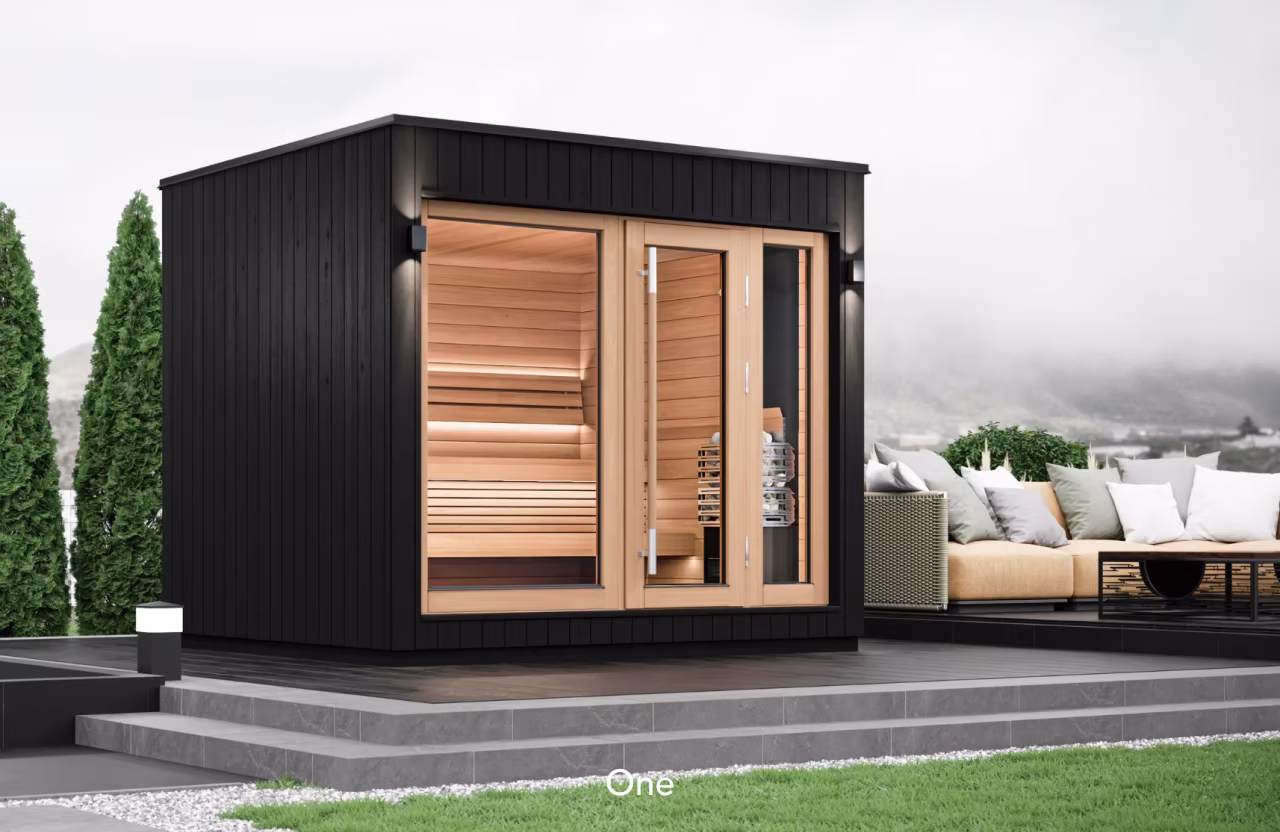 Modern outdoor sauna with wooden interior and glass door.