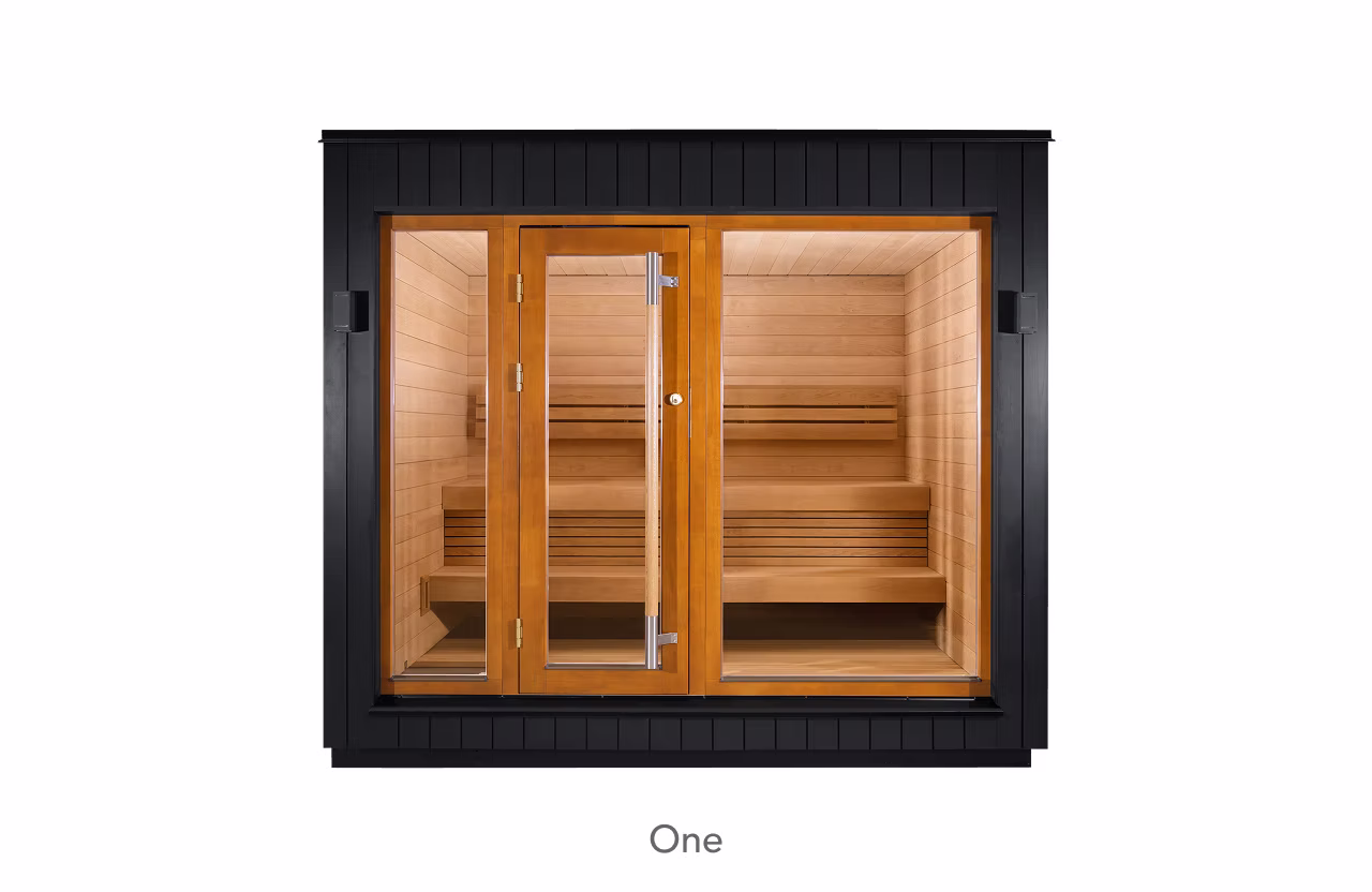 Modern wooden sauna room with glass doors and benches inside.