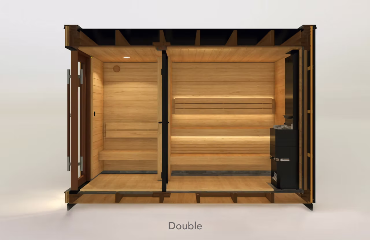 Modern double sauna room with wooden interiors and glass doors.