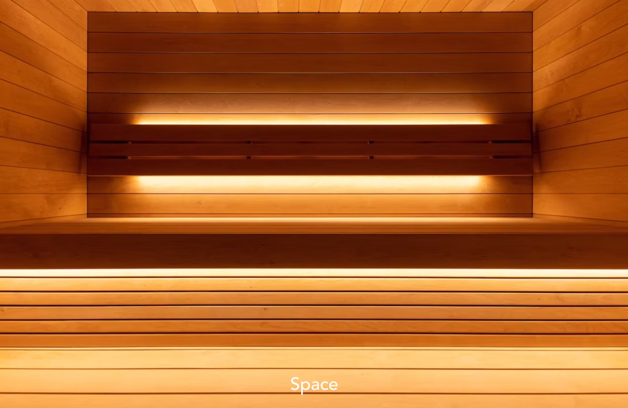 Warm wooden sauna interior with glowing lights.