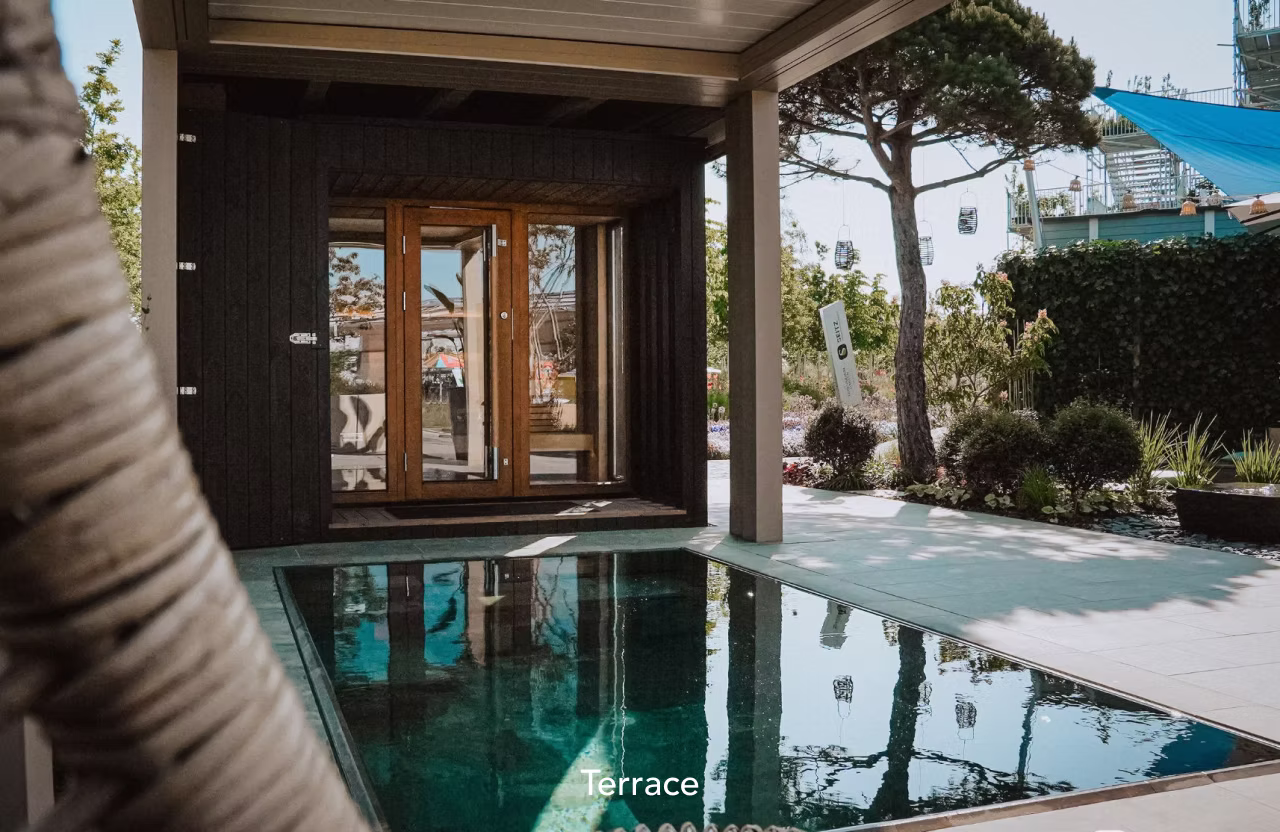 A serene terrace with a small pool and wooden doors.