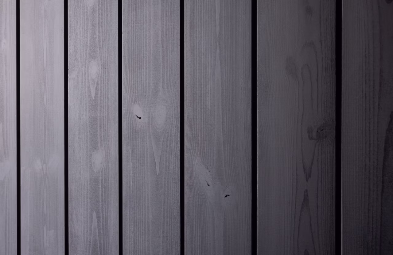 Close-up of dark wooden planks with visible grain and knots.