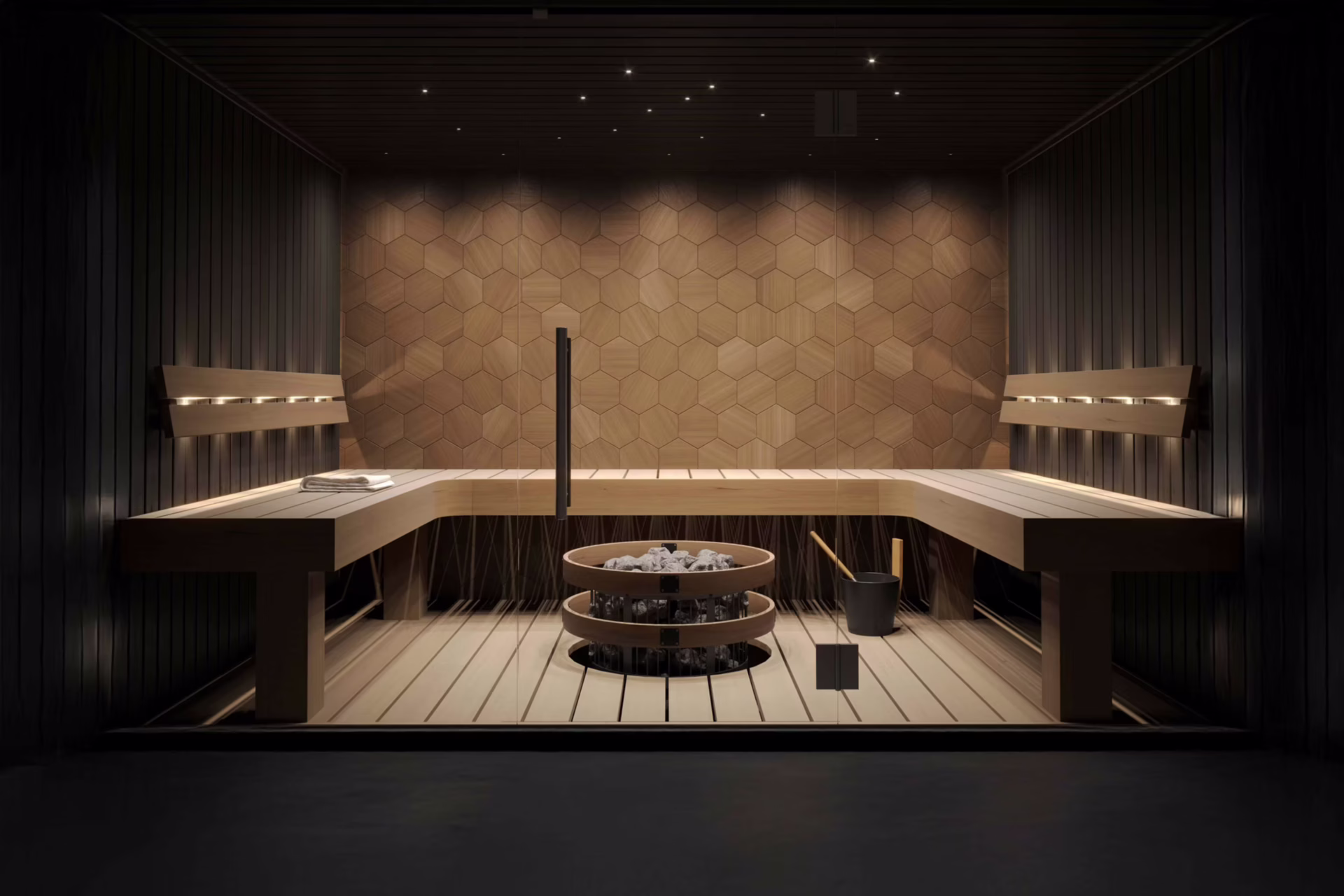 Minimalist sauna interior with wooden benches and central heater.