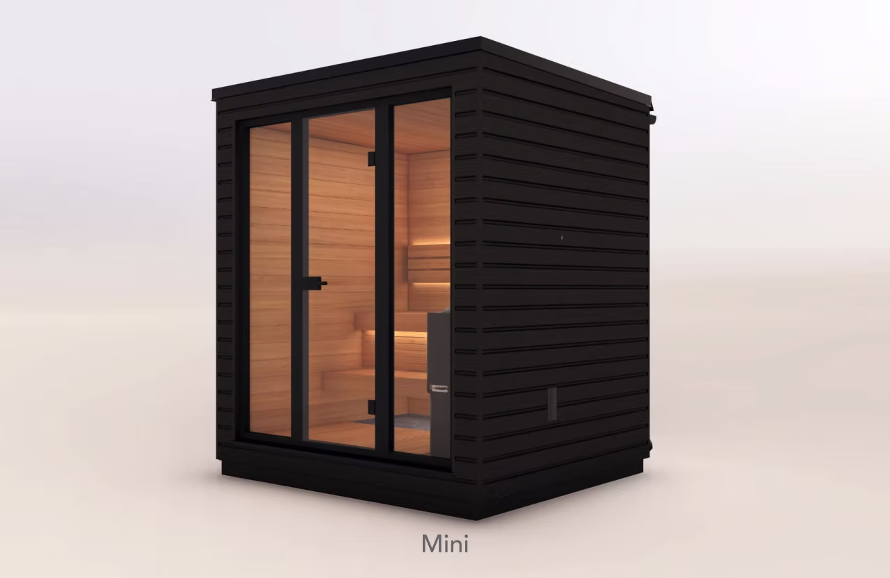 Compact modern black sauna with glass doors and warm interior lighting.