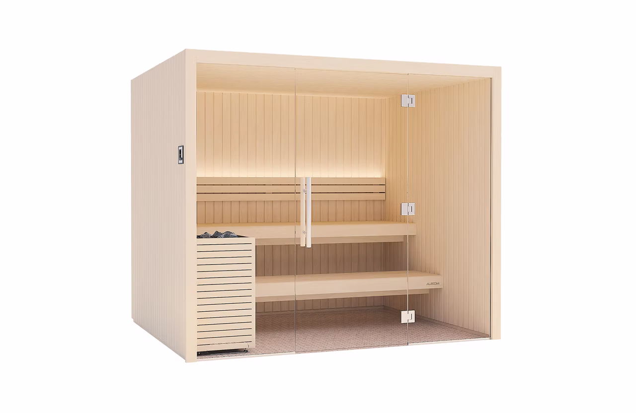 Modern wooden sauna with bench seating and heater.