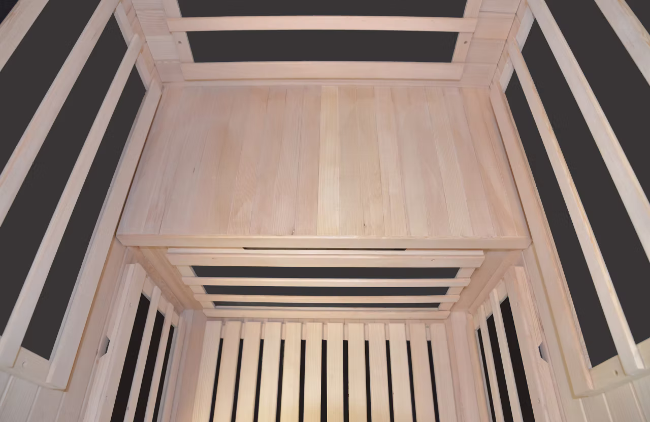 Interior of a wooden sauna with benches and a window.